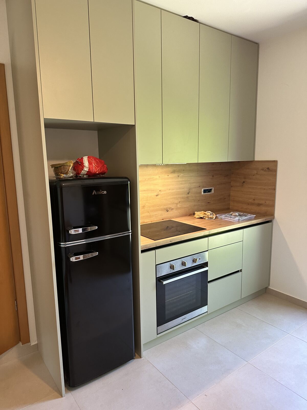 Brisa's new kitchen with a black fridge