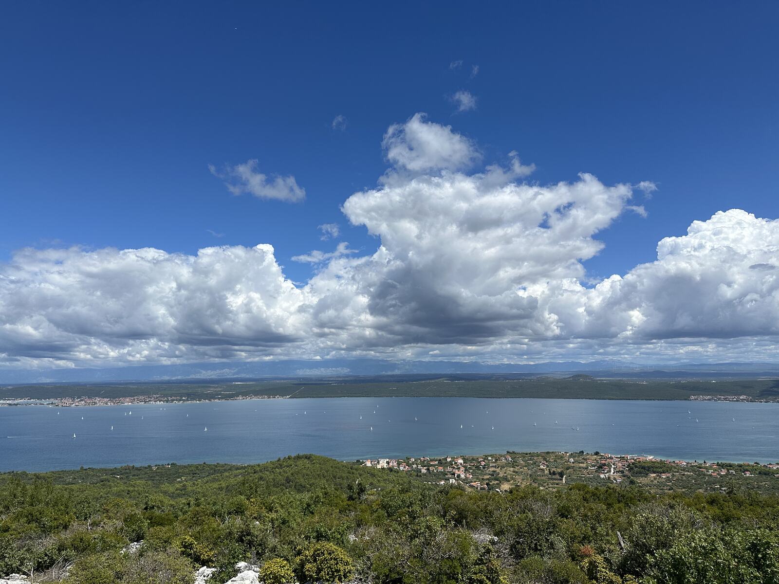 Panorama from Veliki Bokolj: green scrub, the Pašman channel and the mainland under white clouds