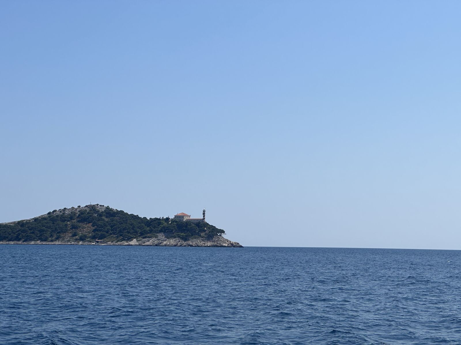 An island with a lighthouse in Telašćica Nature Park, seen from the boat
