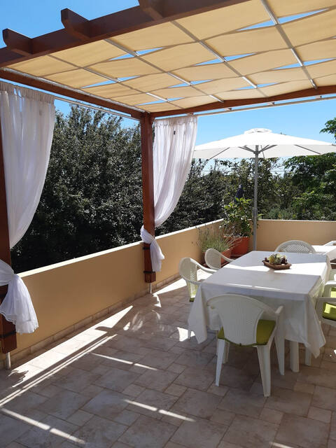 Shaded terrace with a dining table